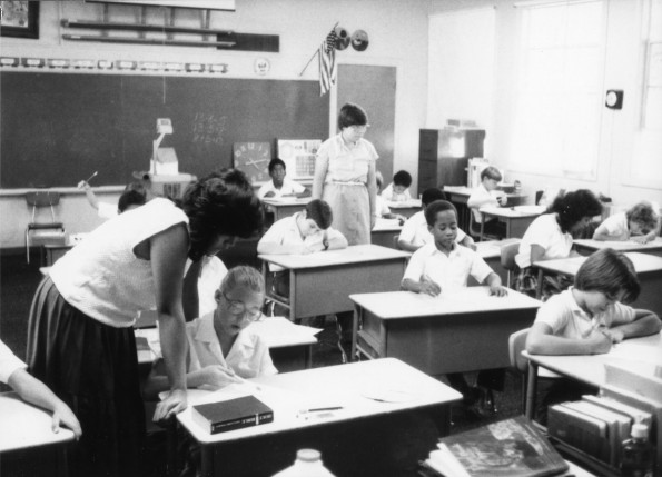 An aide helping a student in Linda Webb's classroom